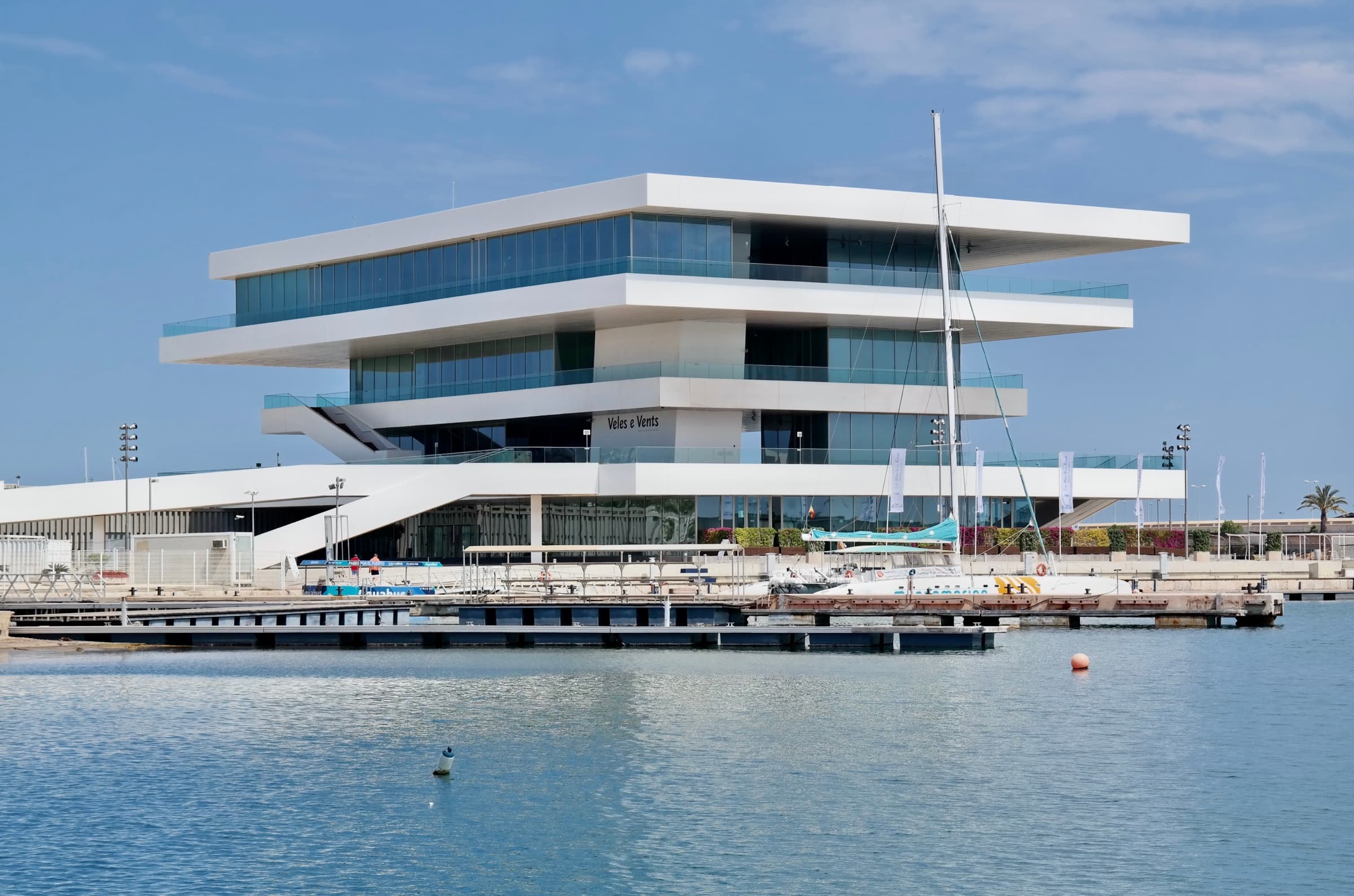 The Veles e Vents building over the Marina de València basin, with a pontoon in the foreground